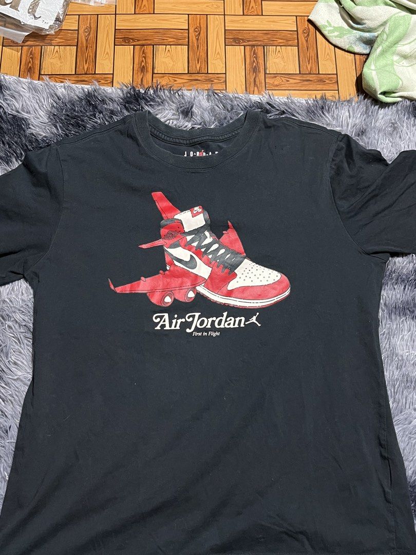 Air Jordan First in Flight Graphic Tee (Category: Tshirts & Polo Shirts ) located in Manila. Submitted by bossddarriel (Listing ID 1436211937, Image 3). Description: - Black Air Jordan graphic tee - Unique design: Sneaker with airplane wings - Crew neck - Short sleeves - Graphic includes "Air Jordan" and "First in Flight".