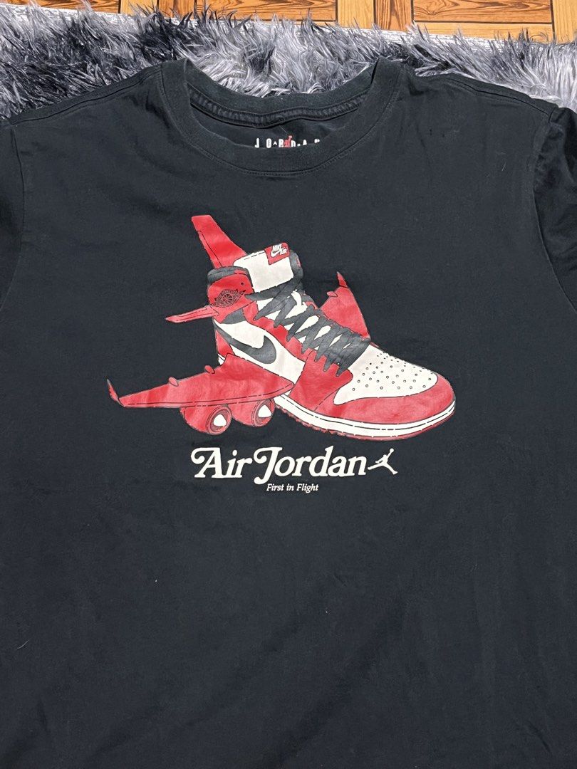 Air Jordan First in Flight Graphic Tee (Category: Tshirts & Polo Shirts ) located in Manila. Submitted by bossddarriel (Listing ID 1436211937, Image 1). Description: - Black Air Jordan graphic tee - Unique design: Sneaker with airplane wings - Crew neck - Short sleeves - Graphic includes "Air Jordan" and "First in Flight".