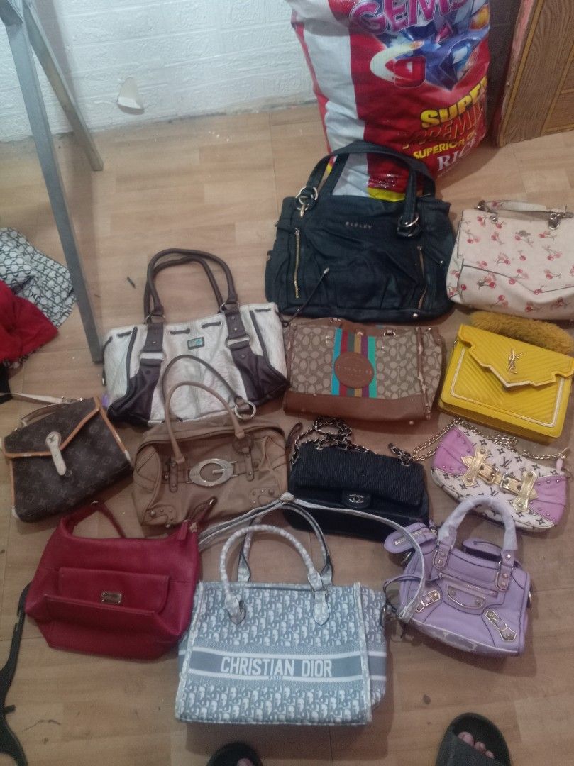 Assorted Handbags (Category: Luxury Bags & Wallets) located in Manila. Submitted by trhiftychong (Listing ID 1436119178, Image 1). Description: Collection of various handbags in different styles and colors. Includes a Christian Dior tote, a black handbag with chain strap, a yellow handbag, and other designs. Some bags feature multiple compartments and handles. Perfect for everyday use or special Brand bags Guuci Lv Sisley Coach Christian Dior Ysl