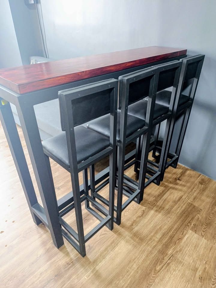 Space Saving Bar Table Set for Food Business, Cafe, Restaurant (Category: Tables & Sets) located in Manila. Submitted by vendorhappy (Listing ID 1436206263, Image 1). Description: Bar Table: - 12L x 54W x 42H inches - Solid mahogany wood top smooth finish - Matte black steel frame Bar Stool 4 pieces: - 11L x 11W x 41.5H inches (29 inches seat height) - Black faux leather back and seat rest cushions - Matte black steel frames Non package price: Ta