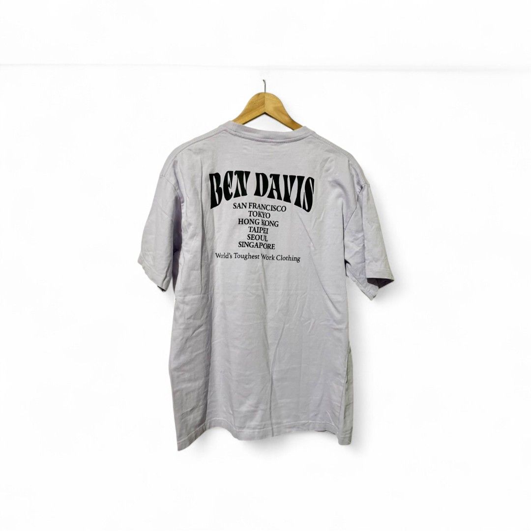 Ben Davis Graphic Tee (Category: Tshirts & Polo Shirts ) located in Quezon City. Submitted by 21st_thrifty (Listing ID 1436228416, Image 2). Description: - Ben Davis graphic tee - Light purple color - Size: XL - Front graphic: Worker and Ben Davis logo - Back graphic: Ben Davis logo and city names - Material: 100% cotton - Color rate 9/10 brand new condition .