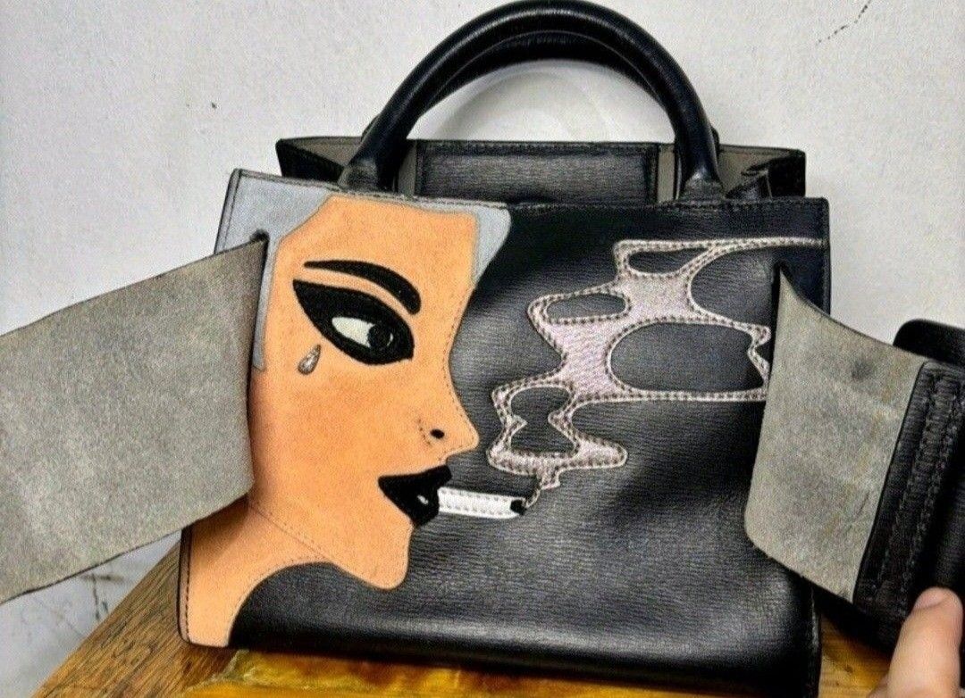 BOYY Handbag with Belt and strap (Category: Luxury Bags & Wallets) located in Quezon City. Submitted by kcobs (Listing ID 1436179677, Image 1). Description: - Black BOYY handbag - Unique design featuring a woman's face - Detachable black belt included - Top handle - Structured shape - Small BOYY logo inside - Distinctive buckle closure - minor signs of use .