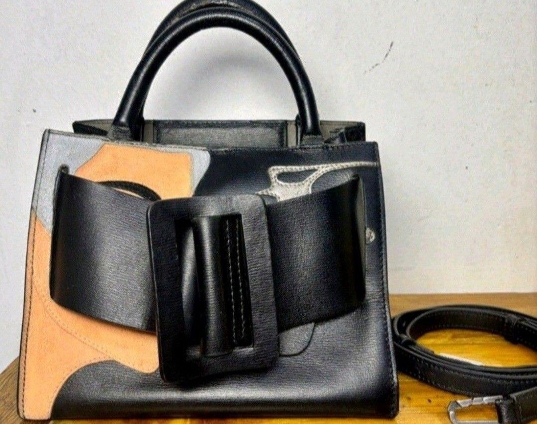 BOYY Handbag with Belt and strap (Category: Luxury Bags & Wallets) located in Quezon City. Submitted by kcobs (Listing ID 1436179677, Image 2). Description: - Black BOYY handbag - Unique design featuring a woman's face - Detachable black belt included - Top handle - Structured shape - Small BOYY logo inside - Distinctive buckle closure - minor signs of use .