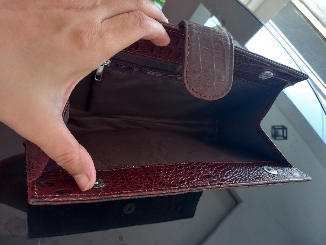 Burgundy brown Crocodile-Embossed Clutch (Category: Clutches) located in Tuguegarao City. Submitted by zenphoenix-7ad615 (Listing ID 1436285566, Image 3). Description: - Burgundy crocodile-embossed exterior - Flap closure with tab - Interior with zippered pocket - Multiple compartments - Handheld design 10.5 by 6 inches.