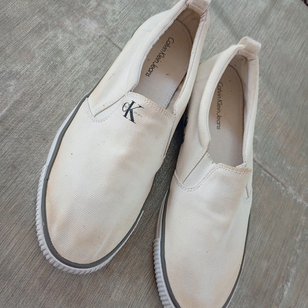 Calvin Klein Jeans Canvass Slip On (Category: Sneakers) located in San Fernando. Submitted by kristhriftshop13 (Listing ID 1436149624, Image 2). Description: washable yellow stain on canvass with code no heeldrag and sockliner issue mop: gcash courier: j&t loc: la union.