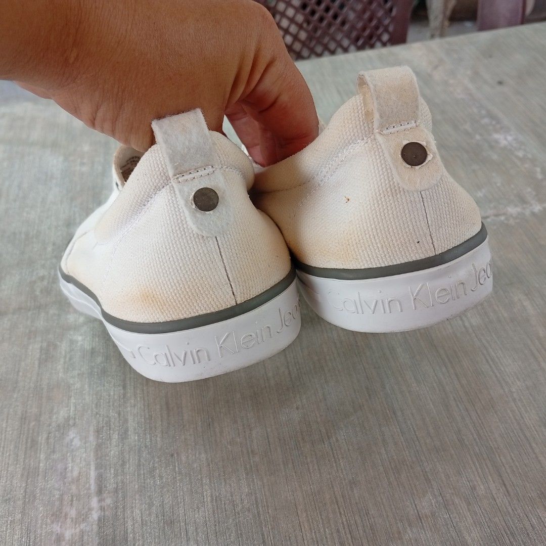 Calvin Klein Jeans Canvass Slip On (Category: Sneakers) located in San Fernando. Submitted by kristhriftshop13 (Listing ID 1436149624, Image 3). Description: washable yellow stain on canvass with code no heeldrag and sockliner issue mop: gcash courier: j&t loc: la union.