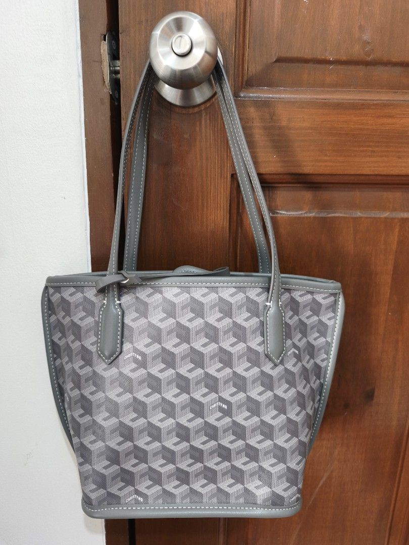 Christy Ng Russo Mini Tote Bag Ash Grey (Category: Tote Bags) located in Manila. Submitted by patc14 (Listing ID 1436108905, Image 2). Description: - Gray tote bag with a unique geometric pattern. - Includes a matching small pouch. - Structured shape with top handles. - Simple and clean design. - Ideal for everyday use or as a fashion statement. - Bought in SM North Edsa Pop Up Store, with original dustbag.