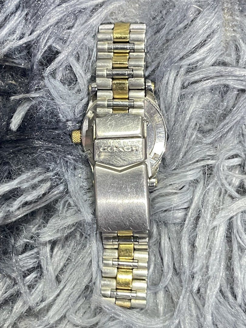 Coach Two-Tone Stainless Steel Watch (Category: Luxury Watches) located in Binangonan. Submitted by chasechloe (Listing ID 1436163339, Image 2). Description: - Coach watch - Silver dial with gold-tone hands and markers - Date display at 3 o'clock - Two-tone stainless steel bracelet - Gold-tone crown - Coach logo visible - Sapphire crystal - Swiss movt..