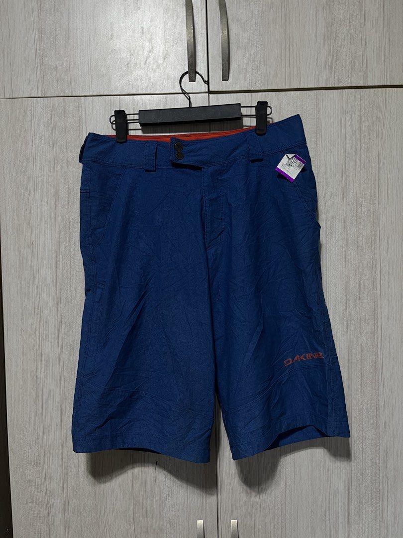 Dakine Blue Shorts Size 32 (Category: Shorts) located in Bulacan. Submitted by sef19 (Listing ID 1436208626, Image 1). Description: - Dakine blue shorts with orange accents - Size 32 waist - Two back pockets - Dakine logo on leg - Made of polyester - Velcro closure - Red interior lining - Designed for outdoor activities.