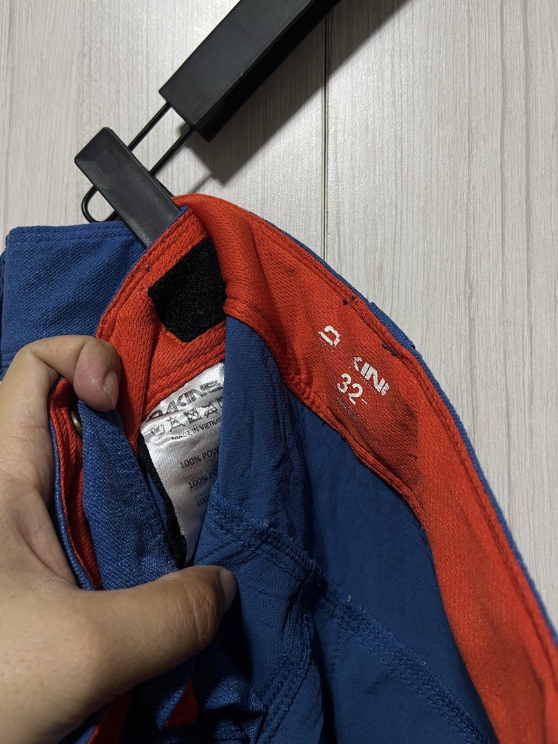 Dakine Blue Shorts Size 32 (Category: Shorts) located in Bulacan. Submitted by sef19 (Listing ID 1436208626, Image 3). Description: - Dakine blue shorts with orange accents - Size 32 waist - Two back pockets - Dakine logo on leg - Made of polyester - Velcro closure - Red interior lining - Designed for outdoor activities.