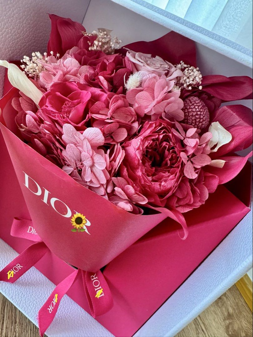Dior Flower Bouquet in Box (Category: Flowers & Bouquets) located in Quezon City. Submitted by lc_ac (Listing ID 1436212275, Image 2). Description: - Dior flower bouquet - Presented in a signature box - Features a mix of vibrant pink flowers - Beautifully arranged and wrapped in Dior-branded paper - Includes a matching ribbon - White box with gold Dior lettering and floral accents - Perfect for Mother’s Day VVIP gift from Dior .