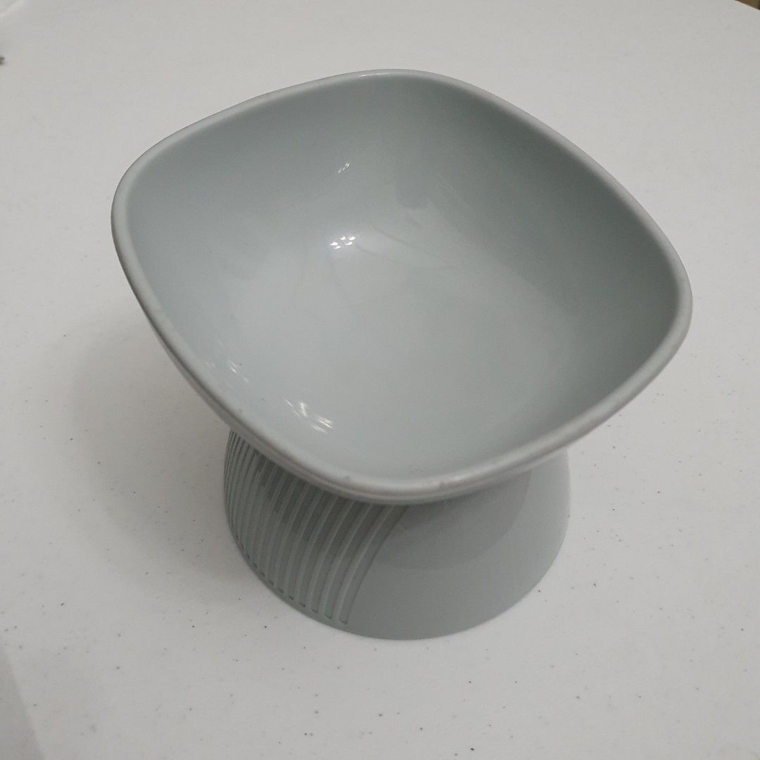 Elevated Pet Bowl (Category: Homes & Other Pet Accessories) located in Paranaque City. Submitted by cobien (Listing ID 1436282814, Image 3). Description: - Stylish gray elevated pet bowl - Unique shape with ribbed base - Dimensions: 5 x 5.25 inches (width/length), 4 inches (height) - Ideal for cats and small dogs - Promotes comfortable eating posture.