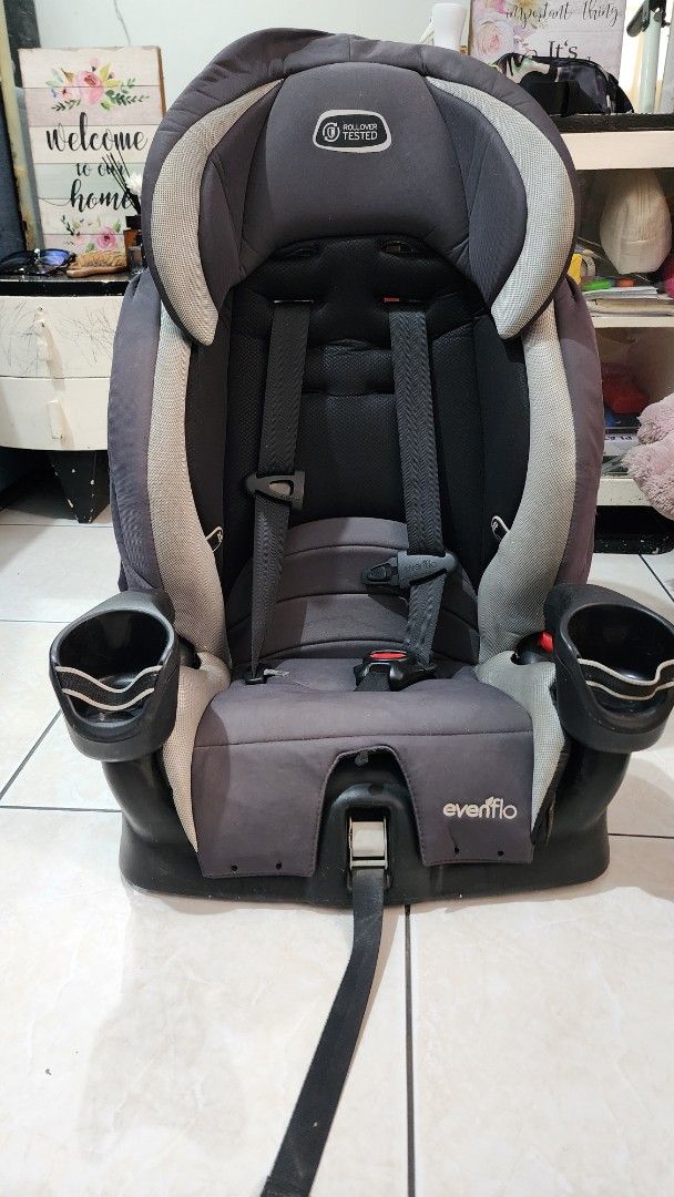 Evenflo Rollover Tested Car Seat (Category: Car Seats) located in Marikina City. Submitted by jbelgica82 (Listing ID 1436282370, Image 1). Description: - Evenflo car seat - Color: Dark grey and light grey - Rollover-tested design - Two cup holders - Adjustable straps - Sturdy base - Evenflo logo visible.