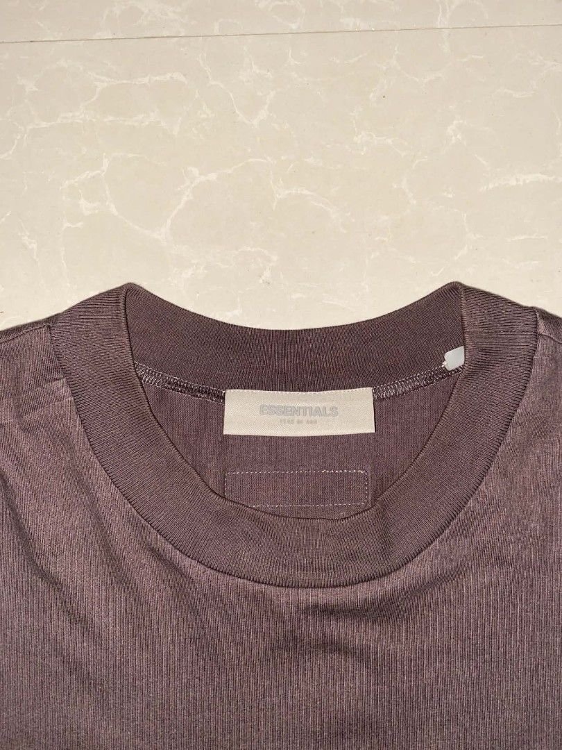 Fear of God Essentials T-shirt (Category: Tshirts & Polo Shirts ) located in Caloocan City. Submitted by roro9822 (Listing ID 1436182078, Image 3). Description: - Fear of God Essentials T-shirt - Size: M (W-25 L-32) - Color: Dark Brown - Material: 100% Cotton - Features the Essentials logo - Made in Vietnam.
