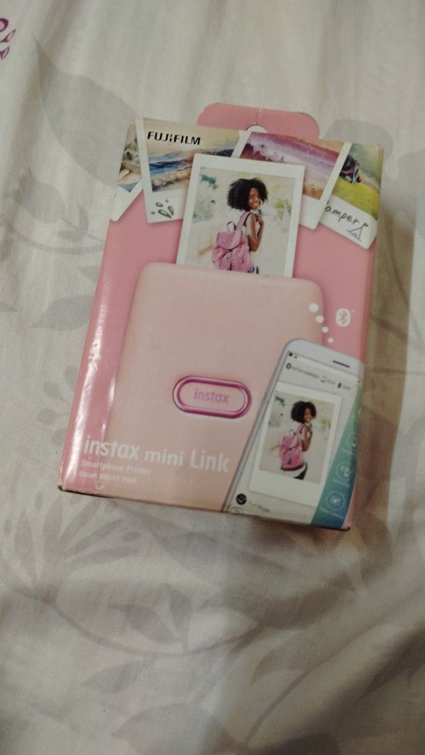 Fujifilm Instax Mini Link Photo Printer (Category: Printers, Scanners & Copiers) located in Caloocan City. Submitted by queenbhiecollection (Listing ID 1436286374, Image 1). Description: - Pink Fujifilm Instax Mini Link printer - Prints photos directly from your smartphone via Bluetooth - Includes the printer, original box, and charging cable - Box shows sample photos.