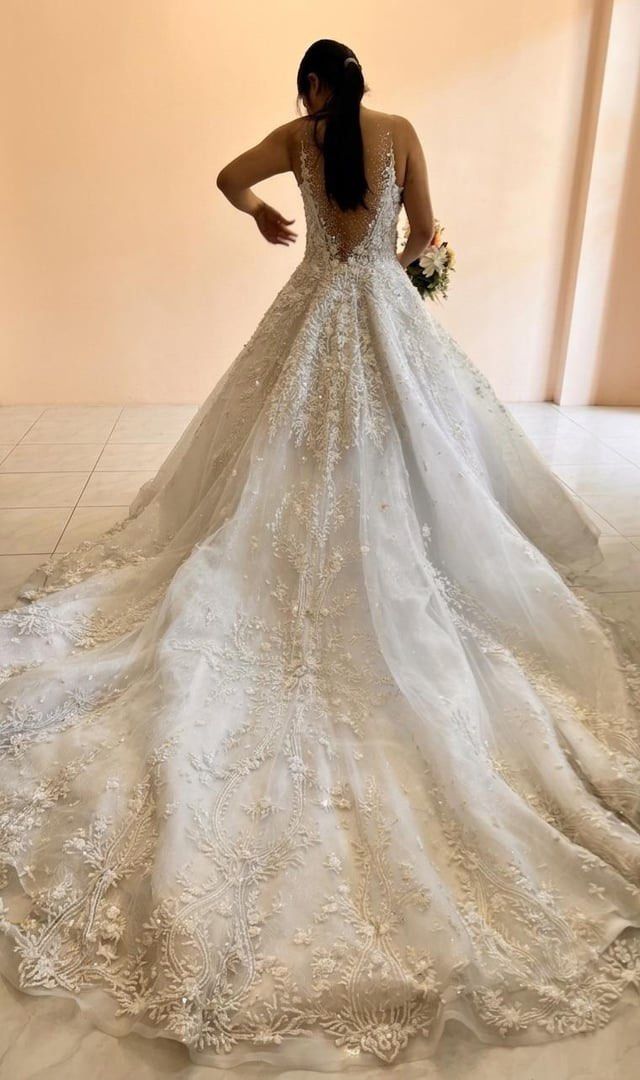 Jazel Sy wedding gown for rent (Category: Evening dresses & gowns) located in Cebu City. Submitted by doubledragon_88 (Listing ID 1436270082, Image 3). Description: - used for ceremony gown - Intricate floral embroidery - Sparkling embellishments - Sheer neckline - Flowing, voluminous skirt - Beautiful train - Flattering silhouette - Petticoat included Bust - 33-34 Waist - 24-25 5’ wearing 3 inches heels Around 13kgs including the box.