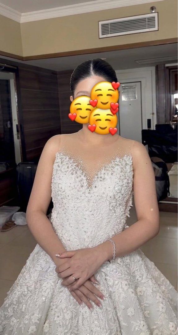 Jazel Sy wedding gown for rent (Category: Evening dresses & gowns) located in Cebu City. Submitted by doubledragon_88 (Listing ID 1436270082, Image 2). Description: - used for ceremony gown - Intricate floral embroidery - Sparkling embellishments - Sheer neckline - Flowing, voluminous skirt - Beautiful train - Flattering silhouette - Petticoat included Bust - 33-34 Waist - 24-25 5’ wearing 3 inches heels Around 13kgs including the box.