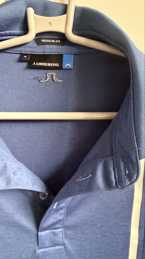 j.lindeberg Blue Polo Shirt (Category: Tshirts & Polo Shirts ) located in Valenzuela. Submitted by dees.corner (Listing ID 1436165722, Image 2). Description: Blue J.Lindeberg polo shirt with white accents. Features the J.Lindeberg logo on the chest and buttons. Made of 100% polyester. Regular fit. Made in Taiwan. Size M. W 17, L 30.