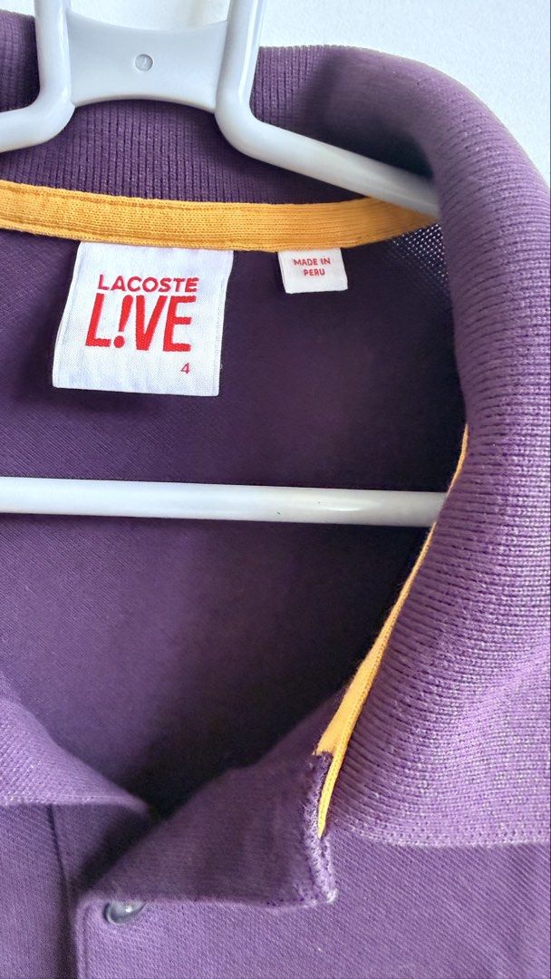 Lacoste Live Purple Polo Shirt (Category: Tshirts & Polo Shirts ) located in Valenzuela. Submitted by dees.corner (Listing ID 1436167069, Image 2). Description: - Lacoste Live polo shirt - Vibrant purple color - Iconic Lacoste crocodile logo - Classic polo collar with yellow trim - Short sleeves - Button-up placket - Made of 96% cotton - W17, L28 - Color rate 9/10.