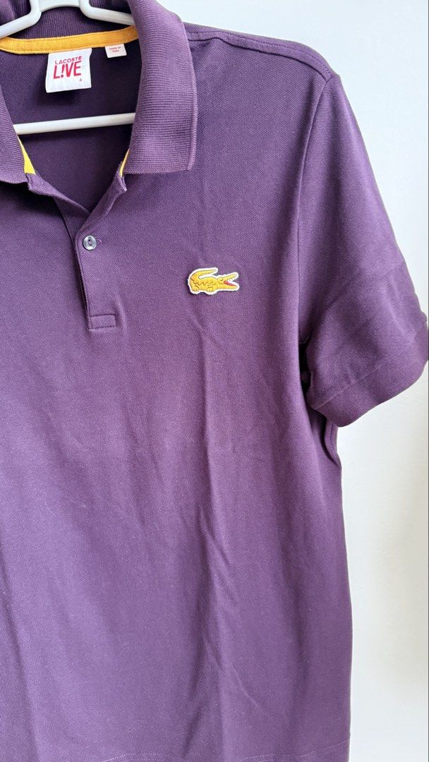 Lacoste Live Purple Polo Shirt (Category: Tshirts & Polo Shirts ) located in Valenzuela. Submitted by dees.corner (Listing ID 1436167069, Image 3). Description: - Lacoste Live polo shirt - Vibrant purple color - Iconic Lacoste crocodile logo - Classic polo collar with yellow trim - Short sleeves - Button-up placket - Made of 96% cotton - W17, L28 - Color rate 9/10.