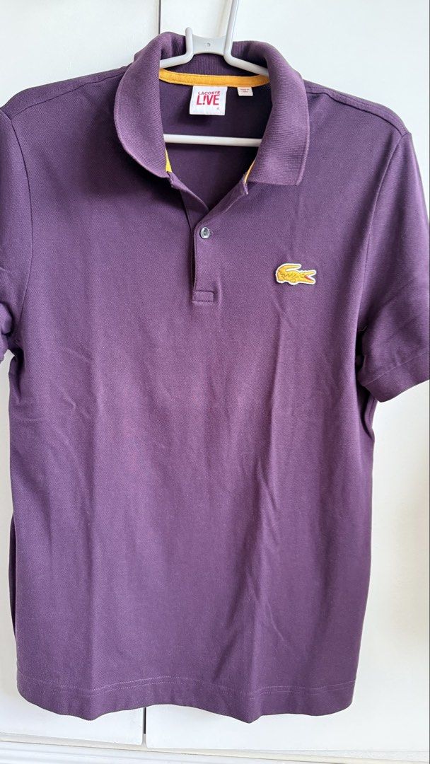 Lacoste Live Purple Polo Shirt (Category: Tshirts & Polo Shirts ) located in Valenzuela. Submitted by dees.corner (Listing ID 1436167069, Image 1). Description: - Lacoste Live polo shirt - Vibrant purple color - Iconic Lacoste crocodile logo - Classic polo collar with yellow trim - Short sleeves - Button-up placket - Made of 96% cotton - W17, L28 - Color rate 9/10.