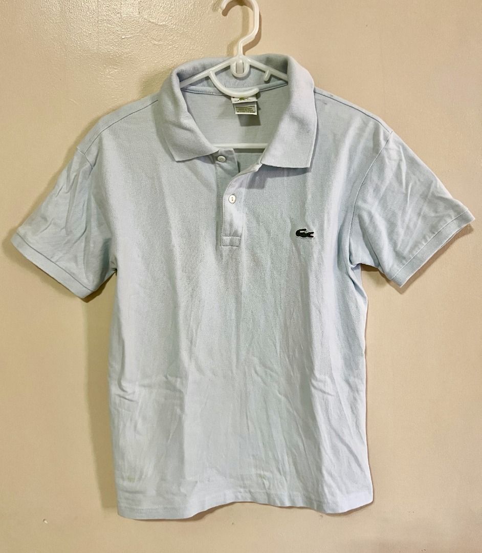 LACOSTE Polo Shirt - Light Blue (Category: Tshirts & Polo Shirts ) located in Taguig. Submitted by LessThan (Listing ID 1436231367, Image 1). Description: Lacoste polo shirt Light blue Size: Body (18" x 24" inches), Sleeves (7" x 6"-8" inches) - Classic polo collar and short sleeves - Made in Peru, designed in France - Button-up placket.