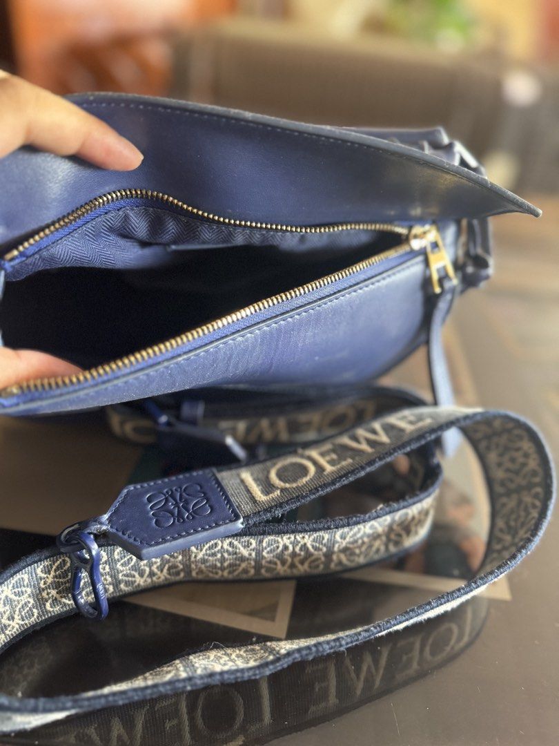 Pre owned L Puzzle Bag Navy Blue (Category: Luxury Bags & Wallets) located in Luna. Submitted by carolina_closetph (Listing ID 1436114970, Image 2). Description: - Authentic Loewe Puzzle bag in navy blue. - Features a top handle and a detachable shoulder strap with the Loewe logo. - Secure zipper closure. - Made from high-quality leather. - Distinctive geometric design..