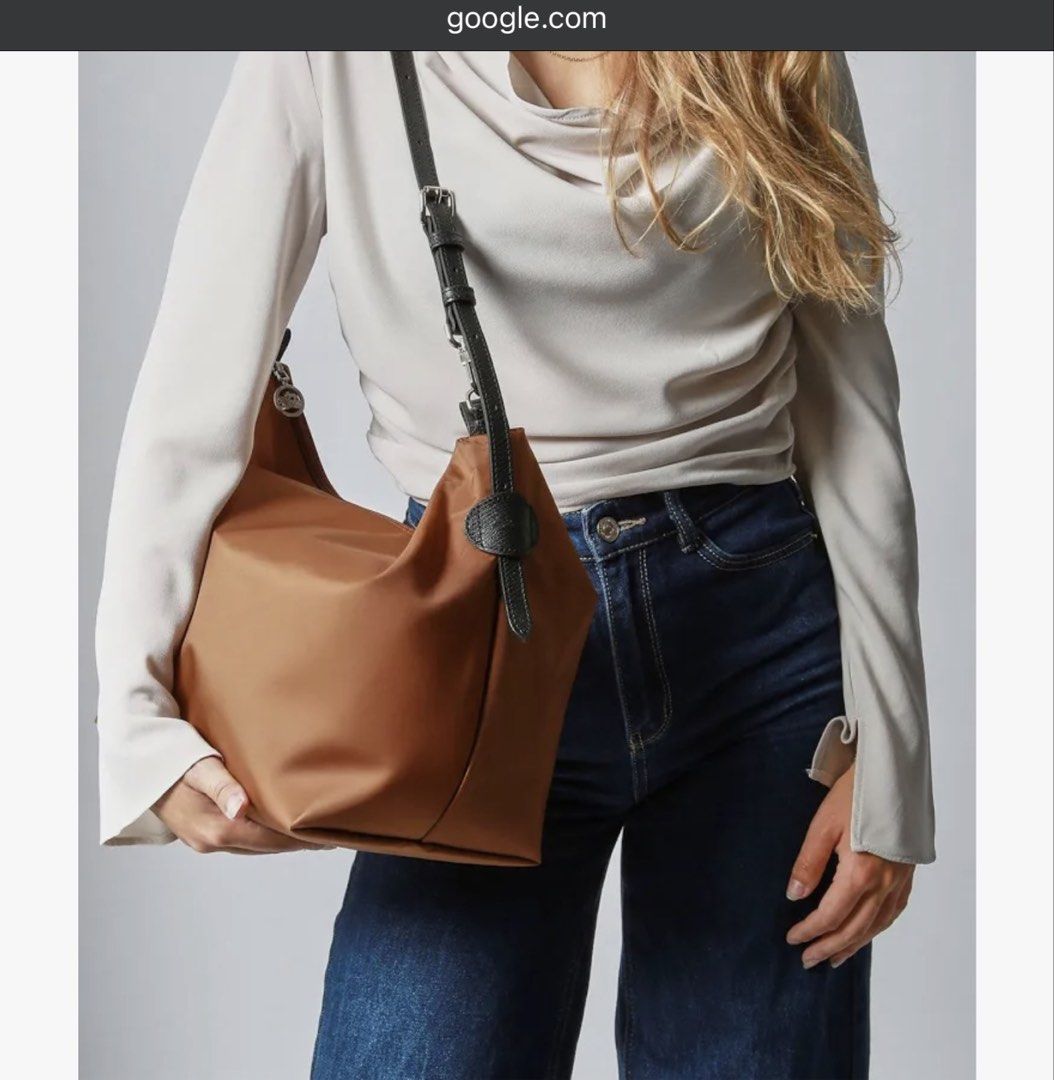 Longchamp Le Slouchy Hobo Bag (Category: Luxury Bags & Wallets) located in Mandaluyong City. Submitted by tidyingupnow (Listing ID 1436203347, Image 1). Description: - Longchamp Le Slouchy Hobo Bag - Cognac nylon exterior - Black leather strap - Medium size - Sleek, modern design - Suitable for everyday use - Versatile style - Zipper closure - Spacious interior.