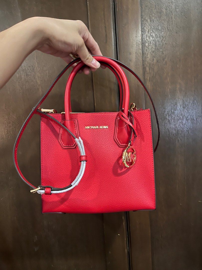 Michael Kors Red Handbag mercer (Category: Luxury Bags & Wallets) located in Manila. Submitted by luckyturtle_6b6bf4 (Listing ID 1436262163, Image 2). Description: - Authentic Michael Kors handbag - Color: Red - Features: - Top handle - Detachable shoulder strap - Gold-tone hardware - Gold logo charm - Material: Textured leather - Condition: Excellent -.