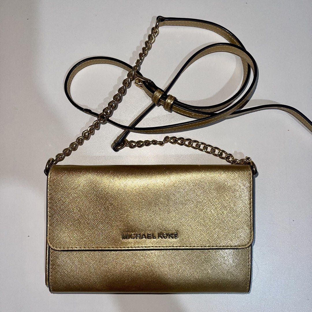Michael Kors sling bag (Category: Shoulder Bags) located in Antipolo. Submitted by hatd0gger (Listing ID 1436223469, Image 1). Description: Pre-loved authentic MK sling bag Price: 4k (negotiable) 🔹Bought it from Michael Kors website and shipped overseas 🔹Gold sling bag convertible to clutch bag (with card compartments) 🔹Looks elegant in actual 🔹Strap hardware still shiny (most part not tarnished) 🔹Dimensions: length (5 inches), width (7.5 in