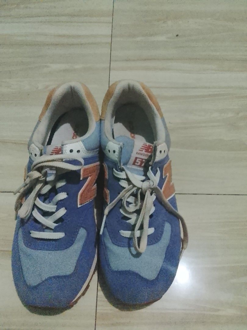 New Balance 574 Blue Sneakers (Category: Sneakers) located in Manila. Submitted by freestone.411e2d (Listing ID 1436202548, Image 1). Description: - New Balance 574 sneakers - Blue and orange color scheme - New Balance logo on side and heel - White laces.