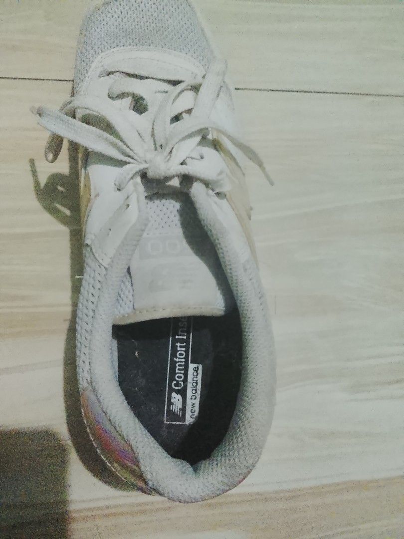New Balance 574 White Sneakers (Category: Sneakers) located in Manila. Submitted by freestone.411e2d (Listing ID 1436201978, Image 2). Description: - New Balance 574 sneakers - Color: White - Mesh upper - Iridescent accents on heel and New Balance logo - "Comfort Insole" branding - White laces - White midsole - Black outsole - Pre-owned condition.
