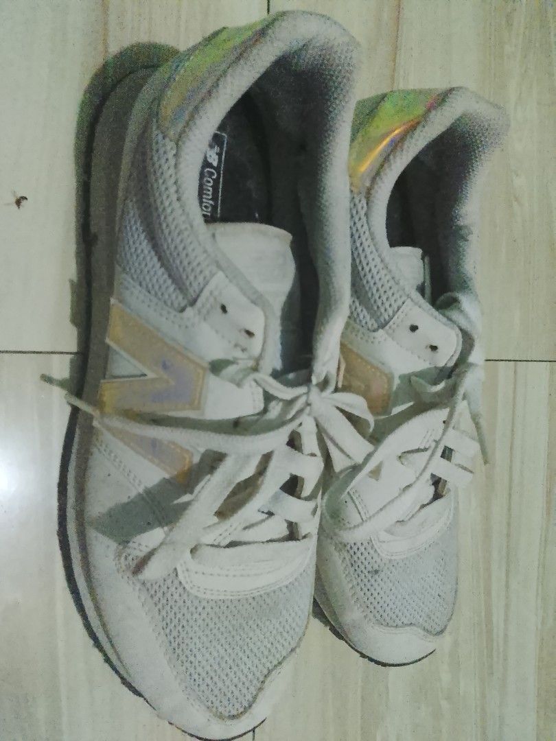 New Balance 574 White Sneakers (Category: Sneakers) located in Manila. Submitted by freestone.411e2d (Listing ID 1436201978, Image 1). Description: - New Balance 574 sneakers - Color: White - Mesh upper - Iridescent accents on heel and New Balance logo - "Comfort Insole" branding - White laces - White midsole - Black outsole - Pre-owned condition.