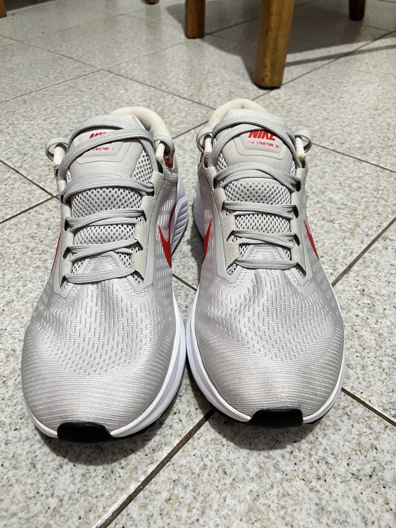 Nike Air Zoom Structure 24 Running Shoes (Category: Sneakers) located in Pasig City. Submitted by emsans (Listing ID 1436117946, Image 3). Description: - Nike Air Zoom Structure 24 - Color: White with red accents - Features: Lace-up closure, Nike swoosh logo Brand New but no box.