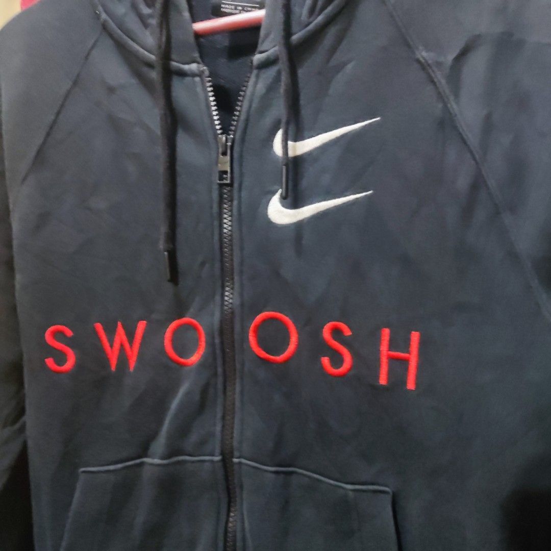 Nike Swoosh Hoodie (Category: Coats, Jackets and Outerwear) located in San Mateo. Submitted by sweetys_closet (Listing ID 1436276619, Image 3). Description: - Navy blue Nike hoodie - White Swoosh logo on front - Full zip closure - Hooded - Front pocket - Embroidered "SWOOSH" in red - Double Swoosh logo on chest.