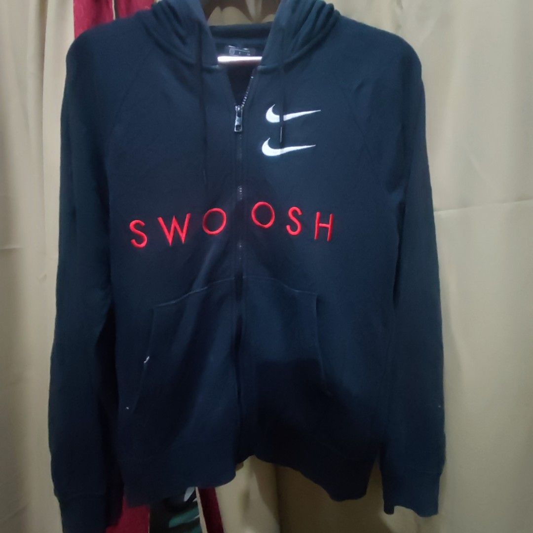 Nike Swoosh Hoodie (Category: Coats, Jackets and Outerwear) located in San Mateo. Submitted by sweetys_closet (Listing ID 1436276619, Image 1). Description: - Navy blue Nike hoodie - White Swoosh logo on front - Full zip closure - Hooded - Front pocket - Embroidered "SWOOSH" in red - Double Swoosh logo on chest.