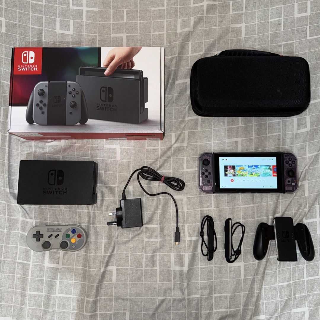 Nintendo Switch V1 Bundle (Category: Nintendo) located in Bacoor. Submitted by the_meowchant (Listing ID 1436161309, Image 1). Description: Nintendo Switch V1 Bundle - Lightly used, still smooth, screen protected since Day 1 - Unit only with premium accessories, no games - Joy-cons modded with custom atomic purple transparent shell - Comes with original box and inclusions (dock, charger, joy-con adapter/straps - With free Skull & Co Carry Case, 8