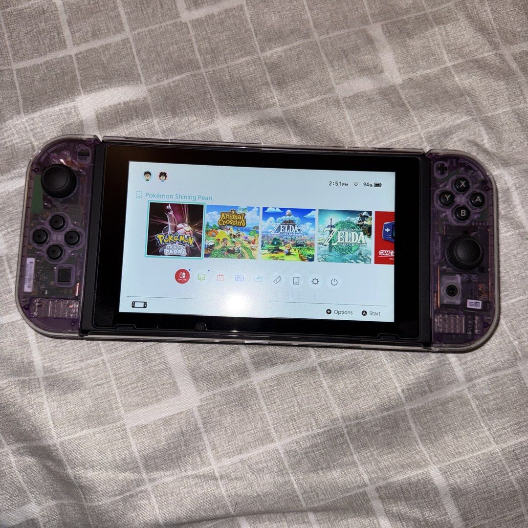 Nintendo Switch V1 Bundle (Category: Nintendo) located in Bacoor. Submitted by the_meowchant (Listing ID 1436161309, Image 2). Description: Nintendo Switch V1 Bundle - Lightly used, still smooth, screen protected since Day 1 - Unit only with premium accessories, no games - Joy-cons modded with custom atomic purple transparent shell - Comes with original box and inclusions (dock, charger, joy-con adapter/straps - With free Skull & Co Carry Case, 8