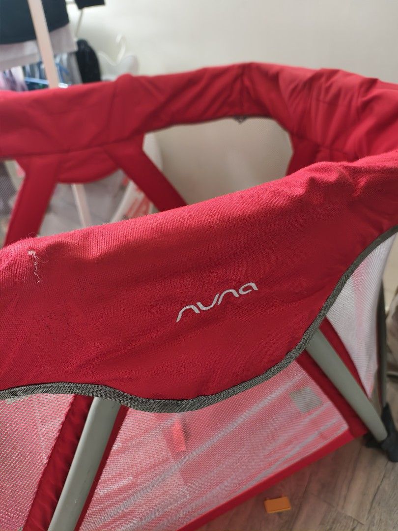Nuna Sena Playard (Category: Cots & Cribs) located in Calamba. Submitted by junethomasb (Listing ID 1436159142, Image 2). Description: - Nuna Sena playard (red color) - Mesh sides - Includes padded mattress - Foldable design for easy storage and transport - Minor fabric tears present.