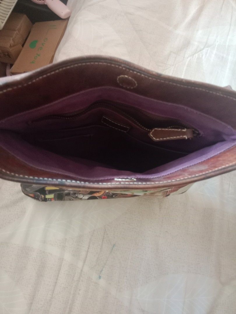 Paul Smith Printed Shoulder Bag (Category: Shoulder Bags) located in Bulacan. Submitted by chubbylicious (Listing ID 1436142798, Image 3). Description: - Paul Smith shoulder/sling canvass with leather bag - Unique printed design - Adjustable brown strap - Spacious interior with purple lining - Multiple compartments - Zippered pocket - Magnetic closure - Vintage-themed exterior - Paul Smith label inside.