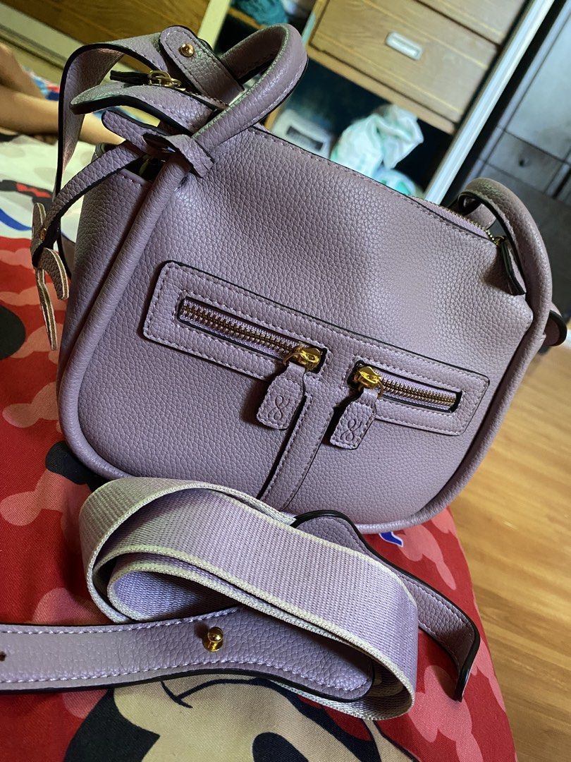 Preloved Holb (Category: Luxury Bags & Wallets) located in Las Pinas. Submitted by csjsoiral-68630 (Listing ID 1436103805, Image 1). Description: - Lavender crossbody bag - Textured exterior - Gold-toned hardware - Top handle - Detachable, adjustable shoulder strap - Two front zippered compartments - Includes logo charm 22cm.