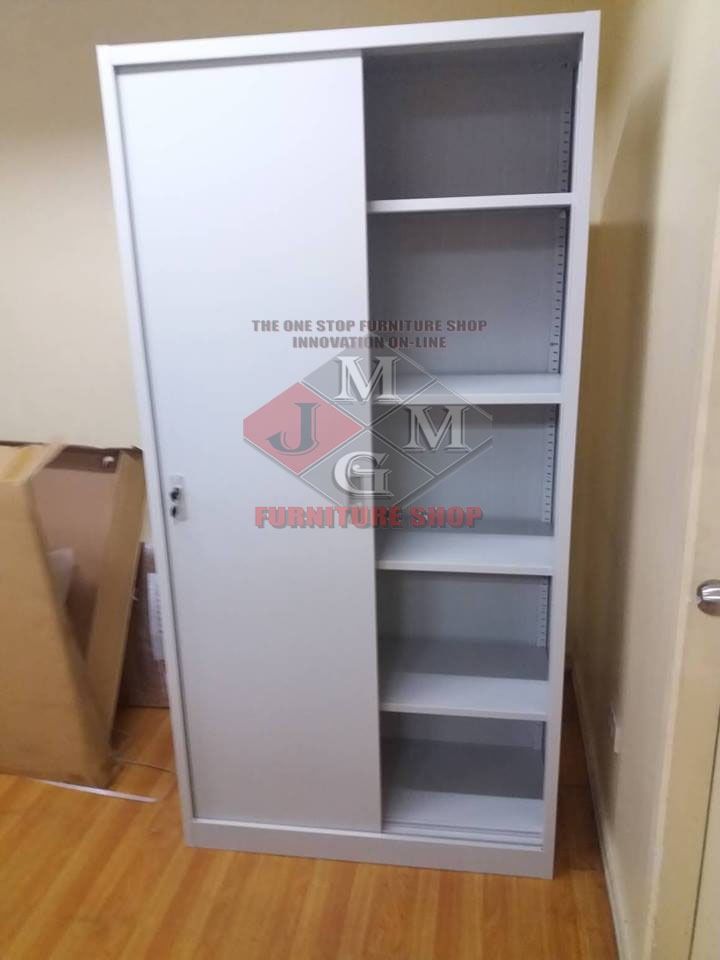 Sliding Door Cabinet with Shelves (Category: Shelves, Cabinets & Racks) located in Caloocan City. Submitted by brightgem-d4ebba (Listing ID 1436151923, Image 2). Description: - Sliding door for easy access - Multiple shelves for organized storage - Made of durable metal - Neutral color to fit any space - Includes a lock for security - Perfect for office supplies or personal items.
