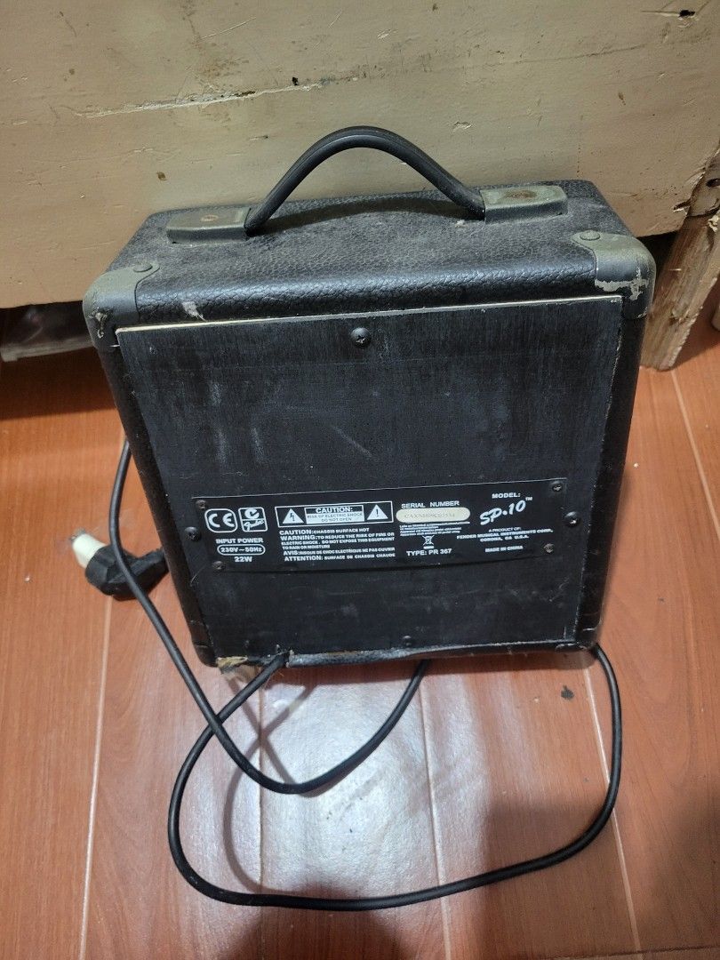 Squier SP-10 Guitar Amplifier (Category: Musical Instruments) located in Manila. Submitted by corruptedw19680 (Listing ID 1436268085, Image 2). Description: - Squier SP-10 guitar amplifier - Features: - Headphone jack - Gain control - Treble control - Volume control - Power switch included - Black exterior with a carrying handle - Compact size, ideal for practice or small performances - Model number visible on the back.