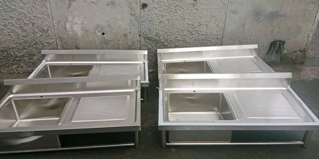 Stainless Steel Commercial Sink (Category: Bathroom & Kitchen Fixtures) located in Quezon City. Submitted by maryjoycan74524 (Listing ID 1436217352, Image 3). Description: - Commercial stainless steel sink - Single basin design - Includes drainboard - Features a lower shelf for storage - Comes with a faucet - Made of durable stainless steel - Perfect for restaurants and food businesses - Heavy-duty construction - Multiple units available.