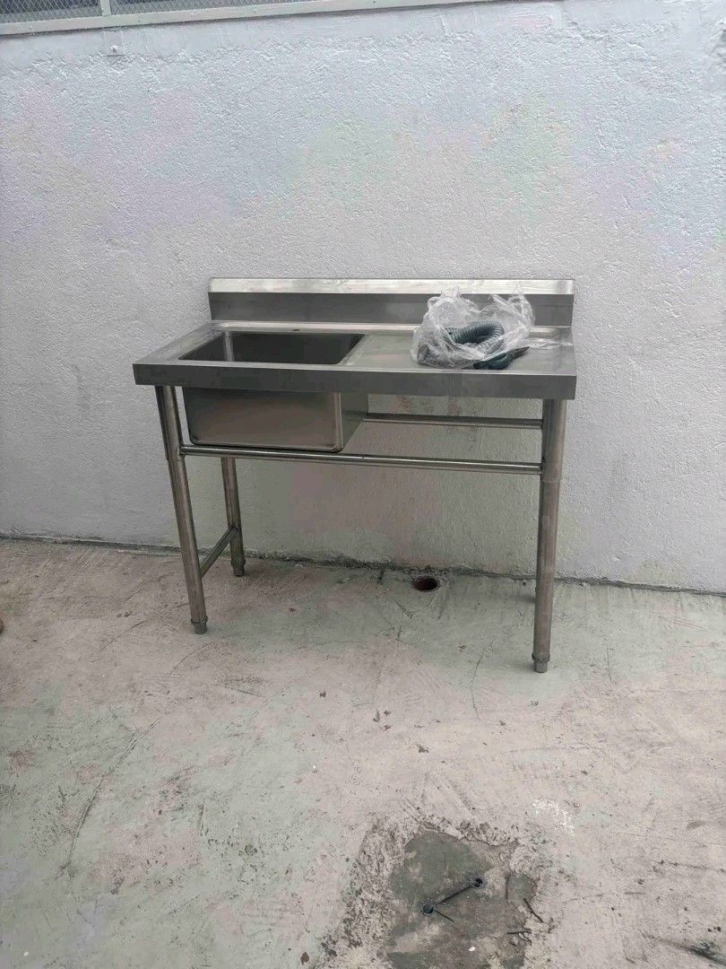Stainless Steel Commercial Sink (Category: Bathroom & Kitchen Fixtures) located in Quezon City. Submitted by maryjoycan74524 (Listing ID 1436217352, Image 1). Description: - Commercial stainless steel sink - Single basin design - Includes drainboard - Features a lower shelf for storage - Comes with a faucet - Made of durable stainless steel - Perfect for restaurants and food businesses - Heavy-duty construction - Multiple units available.