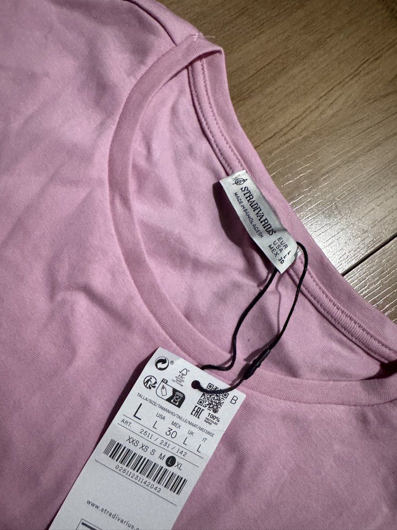Stradivarius Stretchable Short Sleeve Shirt (Category: Shirts) located in Quezon City. Submitted by decluttrqueen (Listing ID 1436260700, Image 2). Description: - Stradivarius short sleeve shirt - Size: L - Color: Pink - Condition: Brand new with tags - Material: Stretchable.