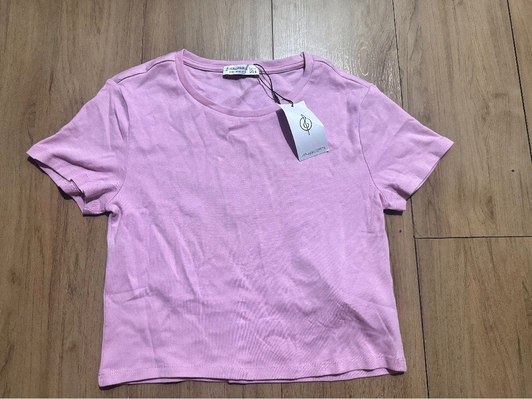 Stradivarius Stretchable Short Sleeve Shirt (Category: Shirts) located in Quezon City. Submitted by decluttrqueen (Listing ID 1436260700, Image 1). Description: - Stradivarius short sleeve shirt - Size: L - Color: Pink - Condition: Brand new with tags - Material: Stretchable.
