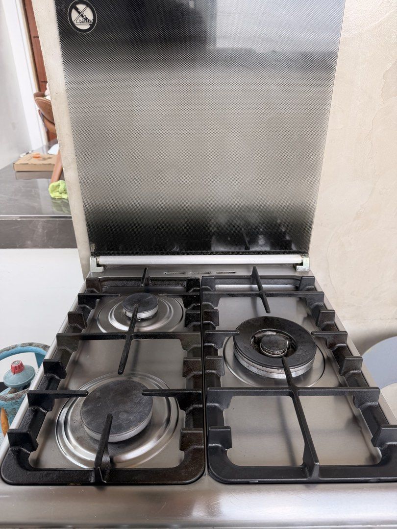 Tecnogas 4-Burner Gas Range with Oven (Category: Ovens & Toasters) located in Quezon City. Submitted by r.tp07 (Listing ID 1436218720, Image 1). Description: - Tecnogas gas range - 3 burners - Oven - Multiple rack levels in oven - Stainless steel finish - Glass cover for burners - Visible control knobs.