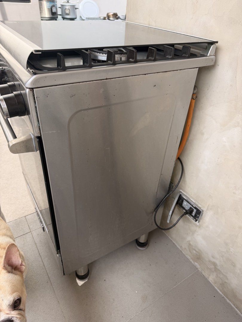 Tecnogas 4-Burner Gas Range with Oven (Category: Ovens & Toasters) located in Quezon City. Submitted by r.tp07 (Listing ID 1436218720, Image 3). Description: - Tecnogas gas range - 3 burners - Oven - Multiple rack levels in oven - Stainless steel finish - Glass cover for burners - Visible control knobs.