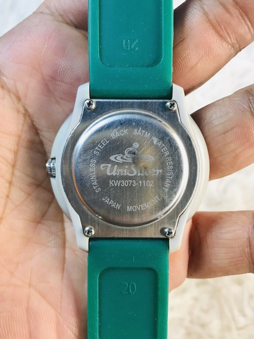 UniSilver Quartz Watch with Green Strap (Category: Women's Watches) located in Manila. Submitted by zerimar01 (Listing ID 1436230422, Image 3). Description: - UniSilver quartz watch - Green strap - Black and gold watch face - Stainless steel back - Water resistant - Model: KW3073-1102 - Strap size: 20.